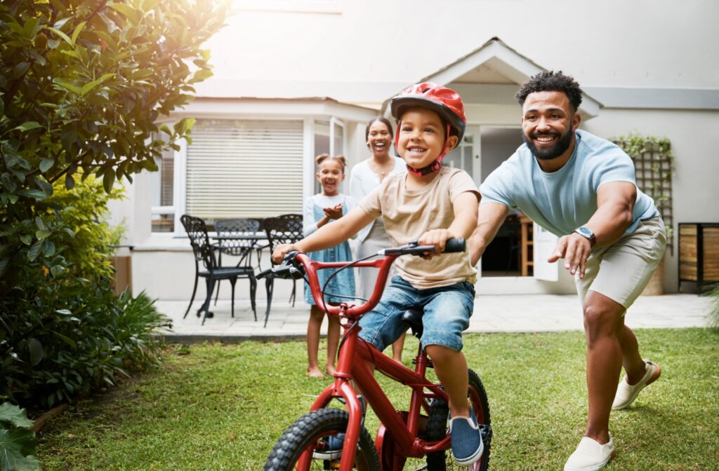 A family plays outside so that the kids are getting adequate sunlight exposure for their eyes to help prevent myopia.