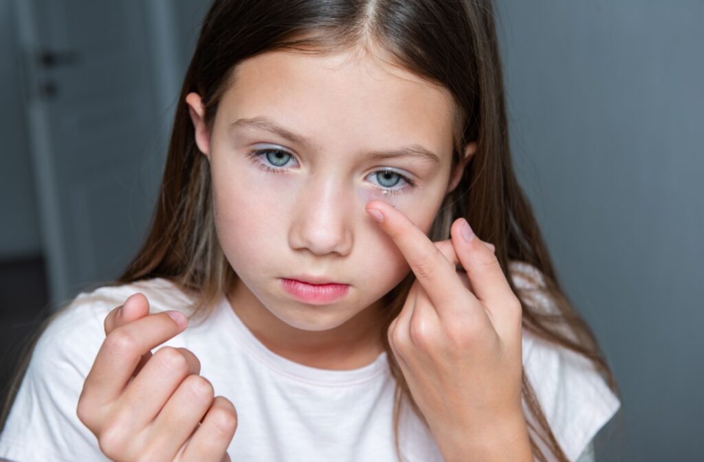 A child inserts their multifocal contact lenses in the morning before school.